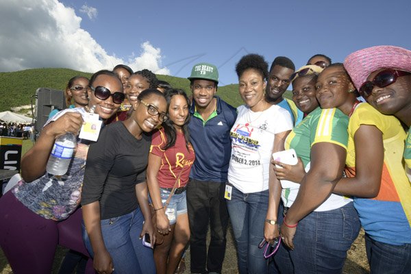 Gladstone Taylor / Photographer

Olympian Athlete Yohan Blake surrounded by supporters of the university of the west indies student's and staff's  attempt to break the guinnes world record for the longest chain of persons clasping hands in a stance against violence at the uwi mona bowl yesterday evening