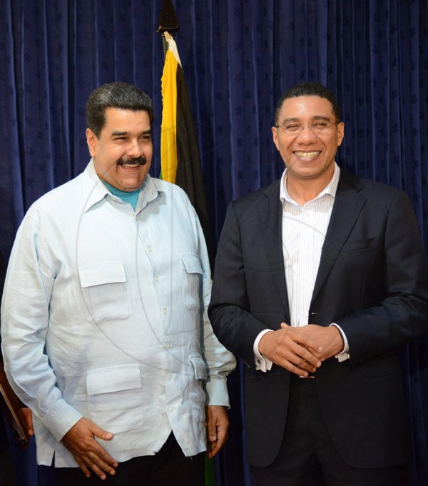 Rudolph Brown/Photographer
Prime Minister Andrew Holness,(right) and Nicolás Maduro, (left) the President of the Bolivian Republic of Venezuela speaks to members of the media after a press conference at Jamaica House during a Working Visit to Jamaica on Sunday, May 22, 2016