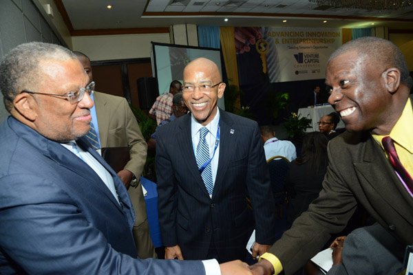 Rudolph Brown/Photographer
Business Desk
Dr Peter Phillips, (left) Minister of Finance Planning and Public Service greets Norman Grant, (right) and Milverton Reynolds, Managing Director of the Development Bank of Jamaica at the Venture Capital One Day Conference at Jamaica Pegasus Hotel in New Kingston on Monday, September 9,2013