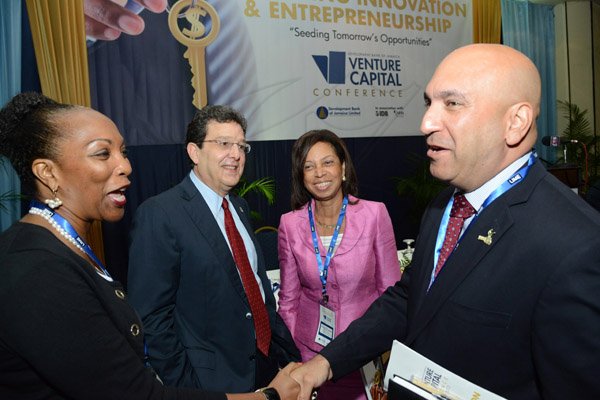 Rudolph Brown/Photographer
Business Desk
PSOJ president Christopher Zacca (right) greets Micro, Small and Medium Sized Enterprise (MSME) Alliance President, Professor Rosalea Hamilton, (left) while Joseph M. Matalon, Chairman of Development Bank of Jamaica and Sharon FFolkes-Abrahams looks on at the Venture Capital One Day Conference at Jamaica Pegasus Hotel in New Kingston on Monday, September 9,2013