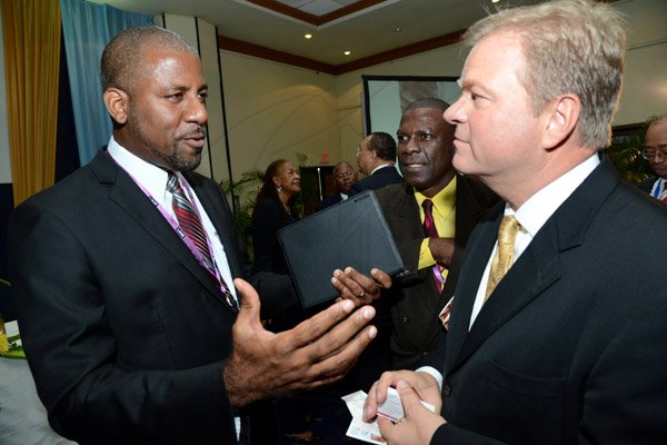 Rudolph Brown/Photographer
Business Desk
Guest speaker Paul Ahlstrom, (right) Managing Director of Alta Ventures Mexico, Alta Group Americas in discussion with Dr. Wayne Henry, Vice President Government Affairs at Scotiabank  at the Venture Capital One Day Conference at Jamaica Pegasus Hotel in New Kingston on Monday, September 9,2013