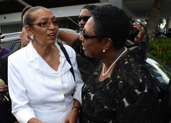 Gladstone Taylor / Photographer

Olivia Grange (right) gave her condolences to  Elaine Perkins 

The funeral serivce for the life of Wilmot Harold Nash Perkins held at the Webster Memorial United Church, Kingston yesterday afternoon