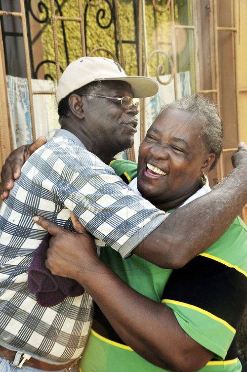 Mark Titus 

Family friend, Kingsley Titer of Sherwood Content and Lillian Bolt, aunt of Usain Bolt, cheer each other up after the Jamaican track star was disqualified from the final of the men's 100 metres in Daegu, South Korea yesterday.