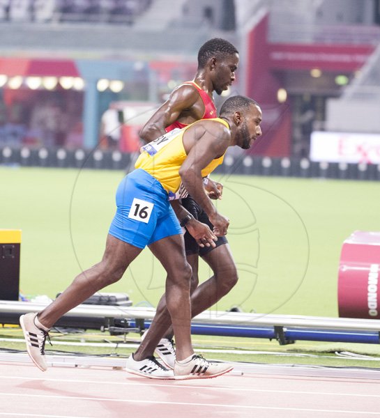 Braima Suncar Dabo of Guinea-Bissau helps Aruba’s Jonathan Busby through the final lap of heat one of the men’s 5000m. Busby was disqualified and Dabo placed thirty-fifth overall with a personal best of 18:10.87.2019 IAAF World Athletic Championships at the Khalifa International Stadium in Doha, Qatar on Friday September 27, 2019