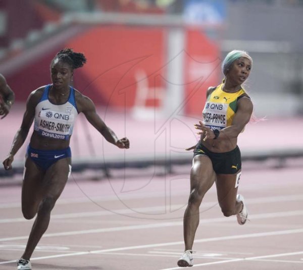Newly crowned world champion in the women 100m shelly-ann Fraser Pryce (second left) looks over at the flash time after crossing the line, winning the 100m women finals at the  2019 IAAF World Athletic Championships held at the Khalifa International Stadium in Doha, Qatar on Sunday September 29, 2019.