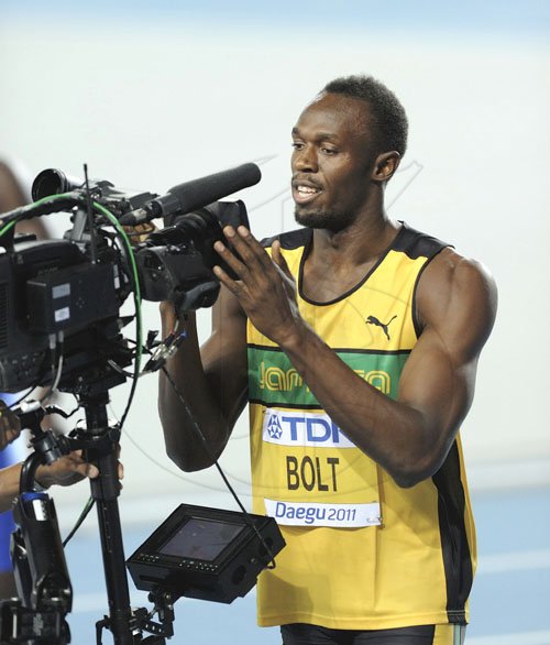 Ricardo Makyn/Staff Photographer
Jamaica's Usain Bolt celebrates by looking into the lens of a television camera, after placing first in his heat of the men's 100m at the World Athletics Championships in Daegu, South Korea, yesterday.


, Aug. 27, 2011. (AP Photo/Martin Meissner)