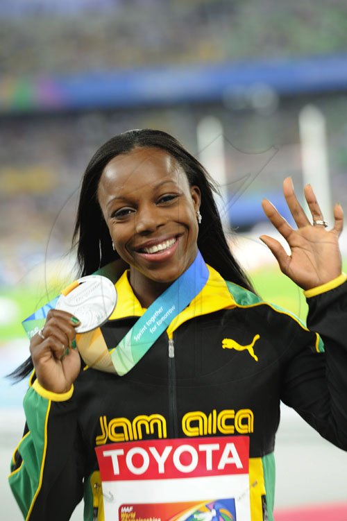 Ricardo Makyn/Staff Photographer                      Vernica Campbell Brown holds with her Silver Medal, August 30, 2011.