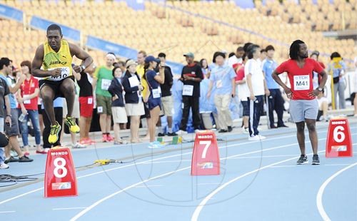Ricardo Makyn/Staff Photographer                                The Gleaner Company's Andre Lowe, Jamaica's representative in the media race at the IAAF World Championships, goes through his warm-up routine prior to the start of the 800m event, at the Daegu Stadium in Daegu, South Korea.


 preparing for his race