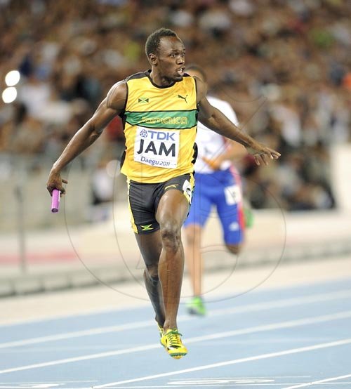 Ricardo Makyn/Staff Photographer
Jamaica's anchor leg runner, Usain Bolt, crosses the finish line to confirm his team's win in a world record 37.04 second, in the mens 4x100 metres final at the World Athletics Championships in Daegu, South Korea, yesterday.


 September4, 2011