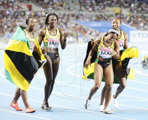 Ricardo Makyn/Staff Photographer
The quartet of (from left) Veronica Campbell-Brown, Kerron Stewart, Shelly-Ann Fraser-Pryce and Sherone Simpson celebrate after breaking the national record to earn silver in the women's 4x100 metres on yesterday's final day of the 13th IAAF World Championships in Daegu, South Korea. Jamaica clocked 41.70 seconds, shaving three-hundreds of a second off the old mark, to place second behind the United States who did 41.56.