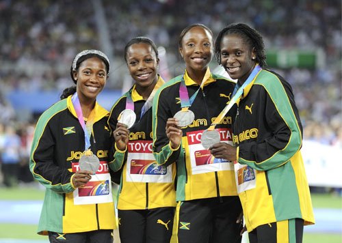 Ricardo Makyn/Staff Photographer
Members of Jamaica's womens sprint relay team (from left) Shelly-Ann Fraser-Pryce, Veronica Campbell-Brown, Sherone Simpson and Kerron Stewart, display their World Athletics Championships silver medals on the podium, during the medal presentation ceremony at the Daegu Stadium in Daegu, South Korea, yesterday.

  4x100 silver, Daegu September 4, 2011.