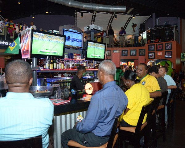 Ian Allen/Staff Photographer
Patrons at the Usain Bolt Track N Records watching the opening match of Woeld Cup 2014 between Brazil and Croatia on Thursday.