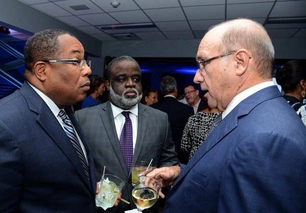 Winston Sill/Freelance Photographer
PUBLIC AFFAIRS and BUSINESS DESKS:----- Industry Minister Anthony Hylton (left) and Dr Eric Deans (centre), chairman of the Logistics Hub Task Force listen keenly to William McConnell. J Wray and Nephew Limited, a Gruppo Campari Company present the Official Opening of the JWN Corporate Office,  at Dominica Drive, New Kingston on Thursday night April 10, 2014.