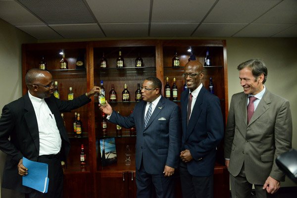 Winston Sill/Freelance Photographer
PUBLIC AFFAIRS and BUSINESS DESKS:----- J Wray and Nephew Limited, a Gruppo Campari Company present the Official Opening of the JWN Corporate Office,  at Dominica Drive, New Kingston on Thursday night April 10, 2014. Here are Rev. Father Kingsley Ashpall (left); Minister Anthony Hylton (centre); Clement Lawrence (second right), Managing Director, Wray and Nephew; and Jean-Jacques Dubau (right), Chairman, Wray and Nephew.