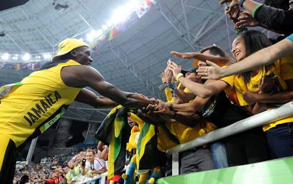 Ricardo Makyn/Staff Photographer 
Rio 2016 Olympics

Usain Bolt is congratulated by adoring fans after his 100m victory at the Olympics in Rio de Janeiro, Brazil, yesterday.