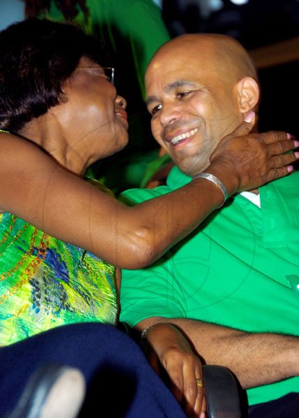 Norman Grindley/Chief Photographer
Lorna Golding, wife of the party leader, gets chummy with James Robertson on the conference platform yesterday.

Jamaica Labour party 67th Annual conference held at the National arena in Kingston November 21, 2010.