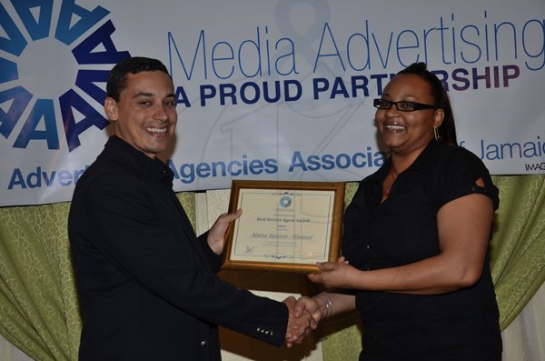 Rudolph Brown/Photographer
The Gleaner Company Advertising team collect the winning advertising media award from Sir Patrick Allen, Governor General of Jamaica at the AAAJ Media Awards luncheon at the Knutsford Court Hotel in New Kingston on Wednesday, July 13-2011