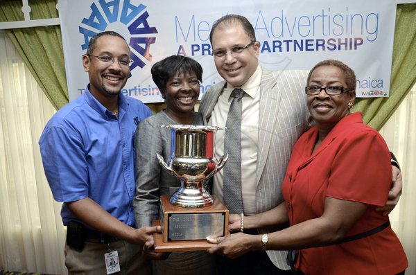 Rudolph Brown/Photographer
 From left: The Gleaner's  Managing Director Christopher Barnes, Advertising and Operations Manager Nordia Craig, Arnold 'JJ' Foote, president of Advertising Agencies Association of Jamaica (AAAJ) and Karin Cooper, business development and marketing manager share a moment with trophy won by The Gleaner Company's advertising team for Media of the Year, at Wednesday's (AAAJ) Media Awards luncheon at the Knutsford Court Hotel in New Kingston.

************************************************************************************************************yesterday. Pictured from left are: Gleaner's general manager Christopher Barnes; Gleaner's advertising and operations manager Nordia Craig; Arnold JJ Foote, president of AAAJ and Karin Cooper, business development and marketing manager