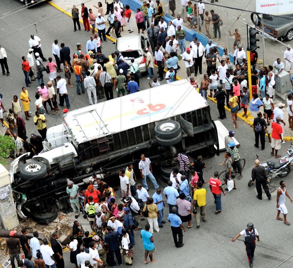 Ricardo Makyn/Staff Photographer.
An aerial view of the accident with a CB Chicken truck and a Nissan Tiida motorcar at the intersection of North and East Street yesterday. A pedestrian was also hit during the accident. The pedestrian along with the driver of the Tiida were taken to hopsital, their condition was not known at press time.