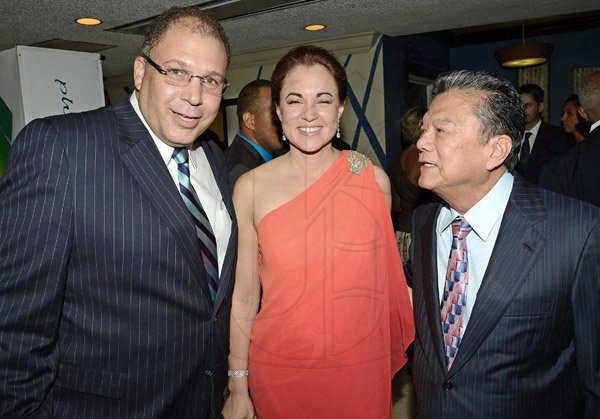 Rudolph Brown/Photographer
J J. Foote (left) greets Lascelles Chin OJ, CD, (centre), founder and executive chairman of LASCO Affiliated Companies and Dr Eileen Chin, managing director of LASCO Manufacturing at Admark 50th Anniversary Banquet at  at the Jamaica Pegasus on Tuesday, April 14