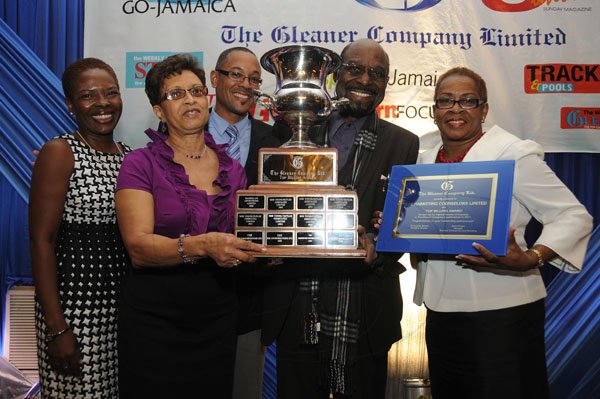 Gladstone Taylor / Photographer

The Marketing Counselors boss Adrian Robinson (second right) and staff member Eileen Lewis (second left) show off the Top Billing award with Gleaner Managing Director Christopher Barnes (centre), Advertising Operations Manager Nordia Craig (left) and Business Development and Marketing Manager Karin Cooper.
Jamaica Gleaner hosts advertisers appreciation and agency awards luncheion held at the jamaica Pegasus, kingston