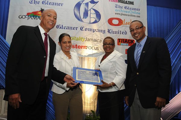 Gladstone Taylor / Photographer

OGM Integrated Communications' Oral McCook (left) and Restaurant of Jamaica's Tina Matalon (second left) accept the second place award from Gleaner Business Development and Marketing Manager Karin Cooper and Gleaner Managing Director Christopher Barnes.

Jamaica Gleaner hosts advertisers appreciation and agency awards luncheion held at the jamaica Pegasus, kingston