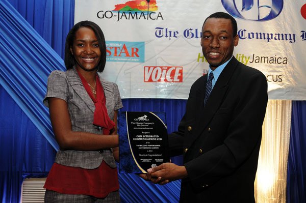 Gladstone Taylor / Photographer

The Gleaner's Roland Booth, presents Terry-Ann Burrell of OGM Integrated Communications with the award for Highest Volume Placed Online - Agency.

Jamaica Gleaner hosts advertisers appreciation and agency awards luncheion held at the jamaica Pegasus, kingston