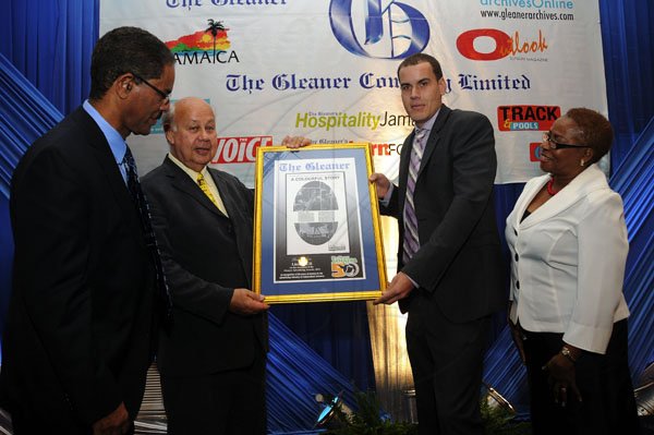 Gladstone Taylor / Photographer

Jason Lindo (second right) of Lindo FCB accepts the Jamaica 50 Award for having an ad on the August 6 edition of The Gleaner from Gleaner Chairman Oliver Clarke (second left). Looking on are Warren McDonald of Berger Paints, Lindo FCB's client for that ad, and Karin Cooper, Gleaner manager - Business Development and Marketing.
Jamaica Gleaner hosts advertisers appreciation and agency awards luncheion held at the jamaica Pegasus, kingston