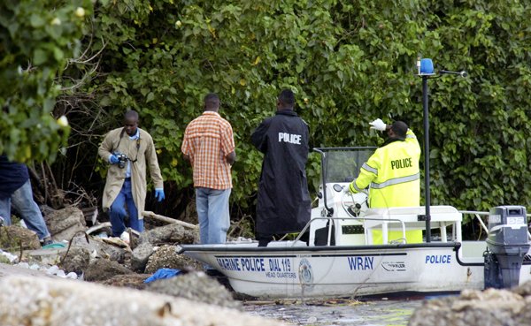 Norman Grindley/Chief Photographer
Marine police process a scene on Michael Manley Boulevard after a body was washed up, September 30, 2010.
