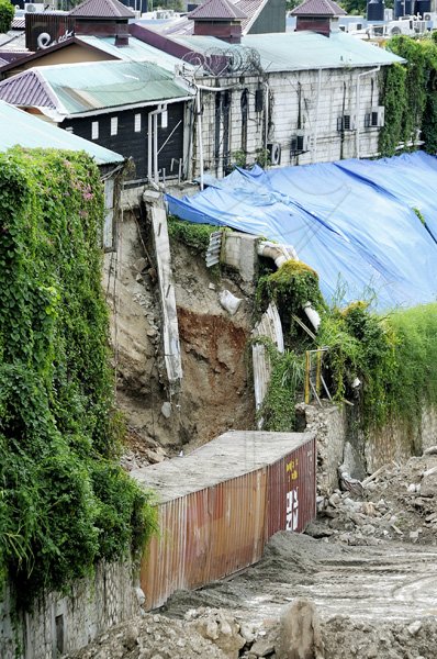 Rudolph Brown/Photographer
A collapsed wall behind shops at the Market Place in St Andrew, above the Sandy Gully. The wall broke away during the heavy rainfall associated with Tropical Depression 16, which was later upgraded to Tropical Storm Nicole last week.