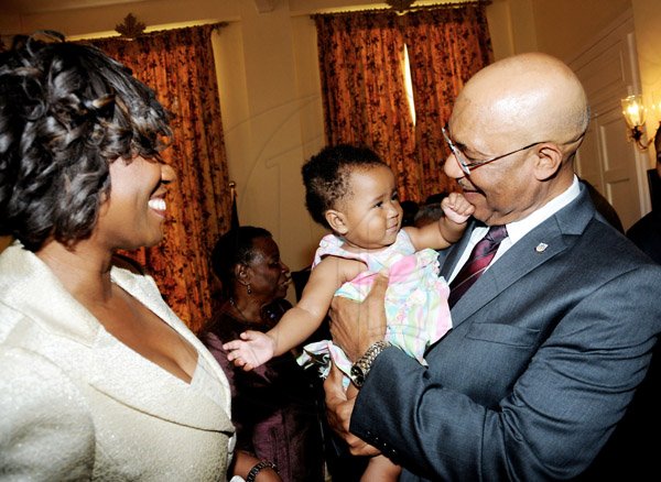 Winston Sill / Freelance Photographer
Swearing-In Ceremony of Dirk E, Harrison as Contractor General, held at King's House, Hope Road on Monday February 25, 2013. Here are Diahann Gordon-Harrison (left); Milan Harrison (Baby); and Governor General Sir. Patrick Allen (right).