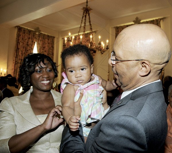 Winston Sill / Freelance Photographer
Swearing-In Ceremony of Dirk E, Harrison as Contractor General, held at King's House, Hope Road on Monday February 25, 2013. Here are Diahann Gordon-Harrison (left); Milan Harrison (baby); and Governor General Sir. Patrick Allen (right).
