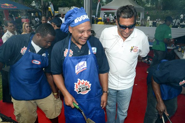 Rudolph Brown/Photographer
Christopher Levy, (right) president and chief executive officer of Jamaica Broilers Group chat with Chef Simon Kelly at All Jamaica Grill Off at Hope Gardens on Sunday, June 9, 2013