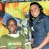 Rudolph Brown/Photographer
Kerry-Ann Brown, of Reggae Jammin presents the winning Mini Chef Kid Grill off trophy to Kyle Nevardo at All Jamaica Grill Off at Hope Gardens on Sunday, June 9, 2013
