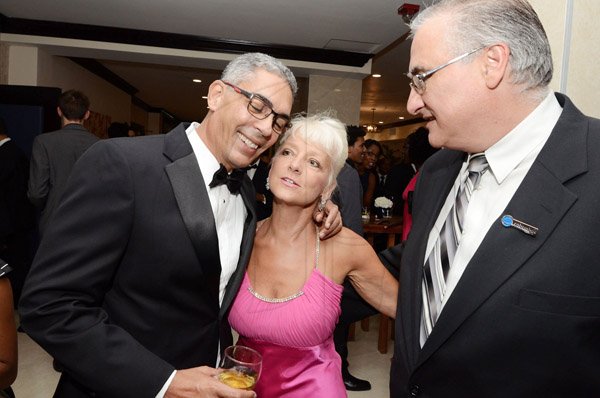 Rudolph Brown/Photographer
Richard Byles, (left) President and CEO of Sagicor greets Kelly Tomblin, CEO of JPSCO while Andrew Fazio, director, Columbus Business Solutions looks on at the AMCHAM Civic Leadership Awards for Excellence 2014 at the Jamaica Pegasus Hotel in New Kingston on Thursday October 23, 2014