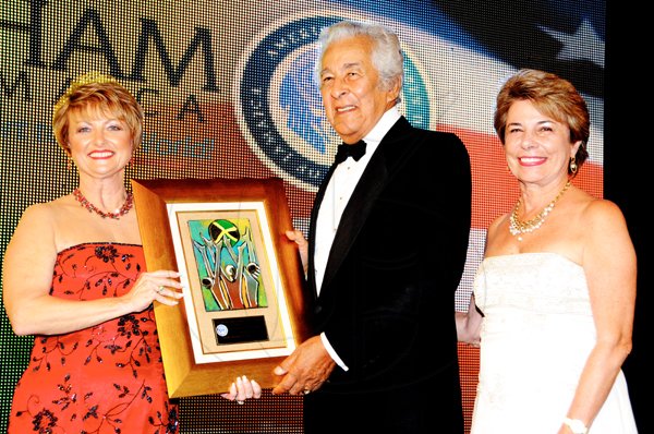 Winston Sill / Freelance Photographer
Becky Stockhausen (left), executive director, the American Chamber of Commerce of Jamaica (AMCHAM)  presents the Lifetime Achievement Award to Honourable Maurice Facey as  Diana Stewart, president, AMCHAM shares the moment.

**************************************************************************************.The AMCHAM Business and Civic Leadership Awards Gala anmd Presentation, held at the Jamaica Pegasus Hotel, New Kingston on Monday night September 26, 2011. Here Becky Stockhausen (left), Executive Director, AMCHAM  presents The Lifetime Achievement Award to Hon. Maurice Facey (centre); looking on at right is Diana Stewart, President, AMCHAM.