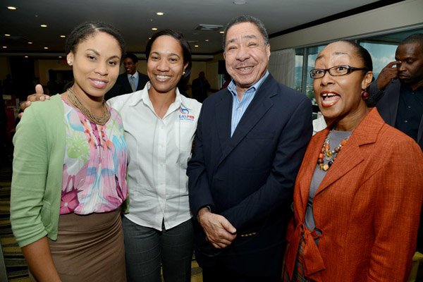 Rudolph Brown/Photographer
Capt. Lloyd Tai, Fly Jamaica pose with from left Ayanna Kirton, Simone Johnson of Gas Pro and Rene Allen Casey, Professional Services Manager of CSS at the AMCHAM Digicel Christmas  luncheon EXTRAVAGANZA at the Jamaica Pegasus Hotel on Thursday, December 5, 2013