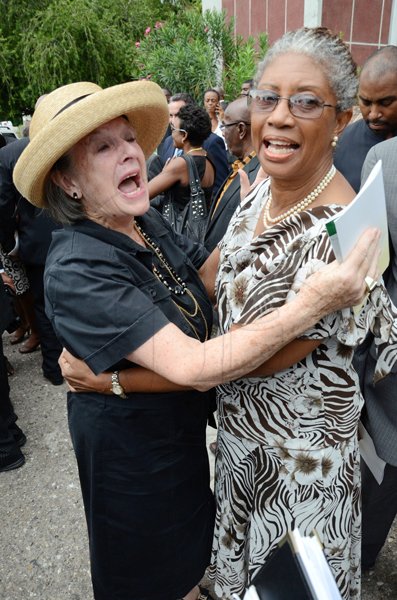 Rudolph Brown/Photographer
Sue greets Beverly Manley at the funeral service for the late Anthony Abrahams at St. Andrew Parish Church on Wednesday, August 17-2011
