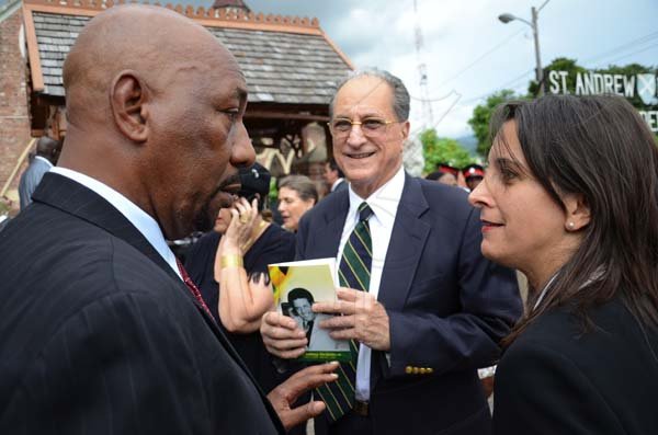 Rudolph Brown/Photographer
Rudyard Spencer, (left) Minister of Health chat with Zien Issa-Nakash and her father John Issa at the funeral service for the late Anthony Abrahams at St. Andrew Parish Church on Wednesday, August 17-2011