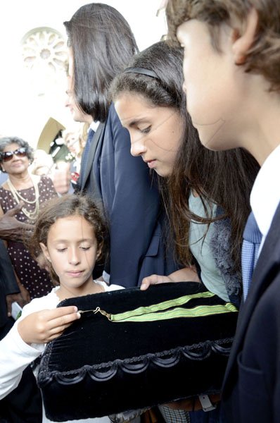 Rudolph Brown/Photographer
Grandchildren of Anthony Abrahams from left Chamotte, Sophie, Max Clivio looking at their grandfather medal of Honour at the funeral service for the late Anthony Abrahams at St. Andrew Parish Church on Wednesday, August 17-2011