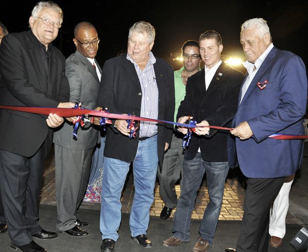 Janet Silvera Photo
 
The Hon. Gordon 'Butch' Stewart, chairman of ATL Automobile (3rd left) and his son Adam (2nd right), deputy chairman gets ready to cut the ribbon with Minister of Investment, Industry and Commerce, Karl Samuda (left), Mayor Charles Sinclair (2nd left) and Minister of Transport and Works, Mike Henry (right) officially opening their state-of-the-art store in Montego Bay. Making his way into the photo op was Minister of Information, Daryl Vaz (green shirt).
