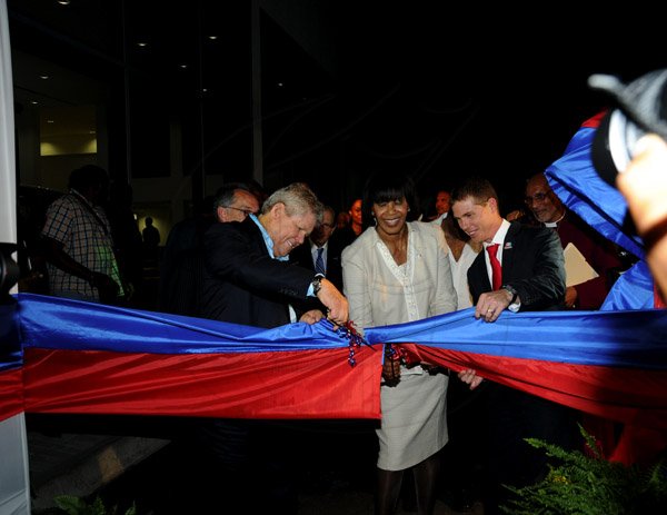 Winston Sill / Freelance Photographer
Prime Minister Portia Simpson-Miller officially open ATL Automotive, Volkswagen and Audi Showrooms, held at Oxford Road, New Kingston on Friday night April 19, 2013. Here Gordon "Butch" Stewart (left); Prime Minister Simpson-Miller (centre); and Adam Stewart (right) cuts the ribbon to open the showrooms.