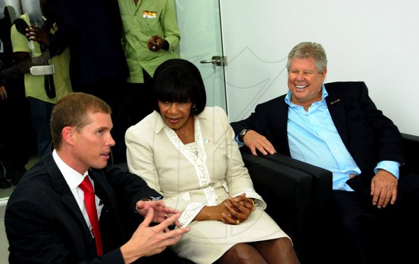 Winston Sill / Freelance Photographer
Prime Minister Portia Simpson-Miller officially open ATL Automotive, Volkswagen and Audi Showrooms, held at Oxford Road, New Kingston on Friday night April 19, 2013.  Here are Adam Stewart (left); Prime Minister Portia Simpson-Miller (centre); and Gordon "Butch" Stewart (right).