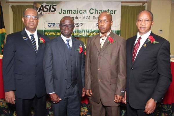 Photograph by Brian McCalla
Awardees from left: Andrew Wynter, Ibrahim Ajagunna and Anthony Brown were awarded plagues while Captian and Chairman Basil Bewry received his Lapel Physical Security Professional (PSP) pin.