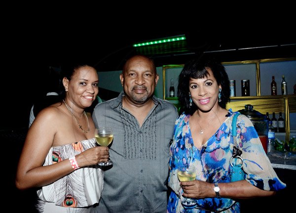 Winston Sill/Freelance Photographer
The American Women's Group of Jamaica (AWGJ) host Escapade Party, held at AISK, College Green Avenue, Hope Pasters on Saturday night May 17, 2014. David Fullwood (middle) is sandwiched by his lovely wife Andrea (left) and the beautiful Sophia Max-Brown