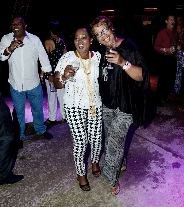 Winston Sill/Freelance Photographer
The American Women's Group of Jamaica (AWGJ) host Escapade Party, held at AISK, College Green Avenue, Hope Pasters on Saturday night May 17, 2014. With drinks in hand, Maureen Shaw (right) and Dureen Brown-Lawson get busy on the dance floor