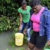 Ian Allen/Photographer
Residents of Free Hill District in Bamboo St.Ann, show where and how they get water since they have no piped water.