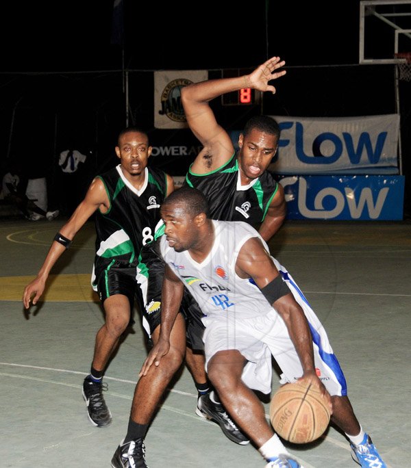 Winston Sill/Freelance Photographer
Urban Knights' Fernando Young (right) dribbles away from Spanish Town Spartans' pair of Michael Blake (right) and Javon Bailey during game one of the best-of-three finals in the Flow/National Basketball League on Friday at the National court. The Knights won 77-75 in triple overtime.