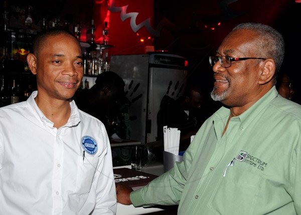 Winston Sill/Freelance Photographer
BDO 50th Anniversary Celebration for staff and clients, held at Fiction Lounge, Market Place, Constant Spring Road on Friday night September 20, 2013. Here are Dennis? Chung (left), of  PSOJ; and John Edwards (right).