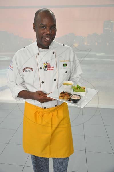 Jermaine Barnaby/Photographer
Chef Dennis McIntosh with one of the meals at The New E-Class Sedan launched on Monday, September 9, 2013 Silver Star Motors Limited, South Camp Rd, Kingston.